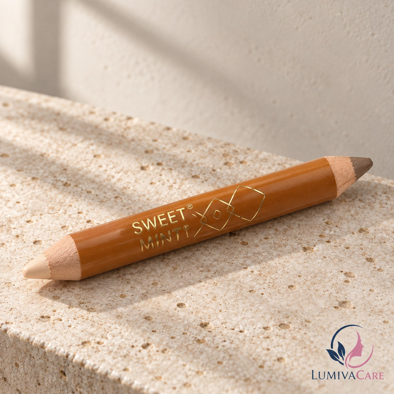 Double-ended contour and highlight pencil on a light stone surface.